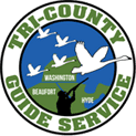 A green circle with the words tri-county guide service in it.